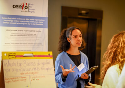 Women having a conversation at a conference stand.
